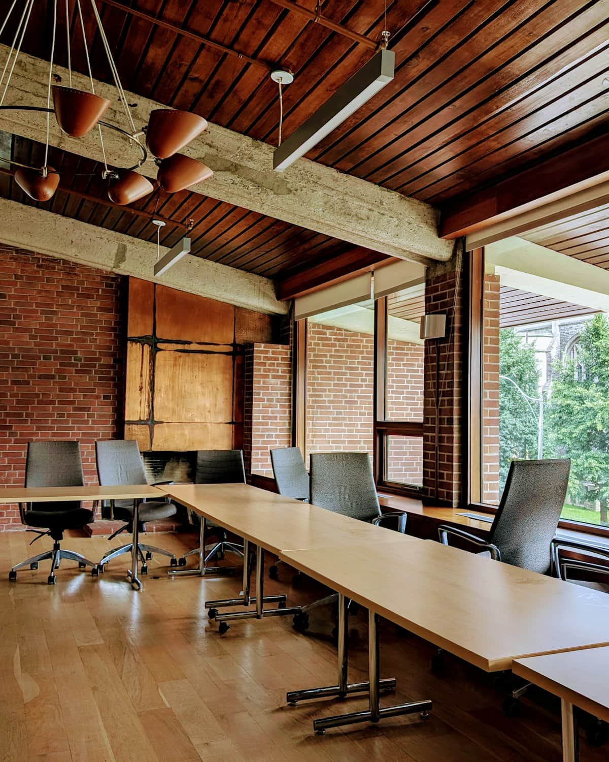 A warm, wood-lined room set for a working session